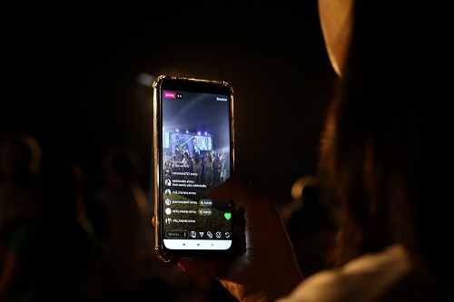 live streaming - the future of events. lady pressing phone